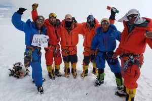 A team celebrating on the summit of Cho Oyu