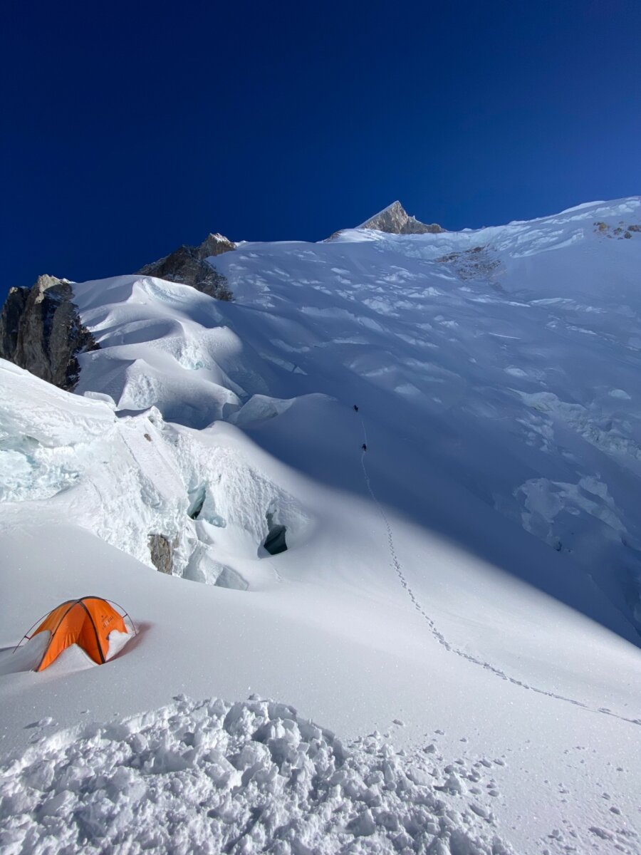 A tent covered in snow on a Gasherbrum II Expedition