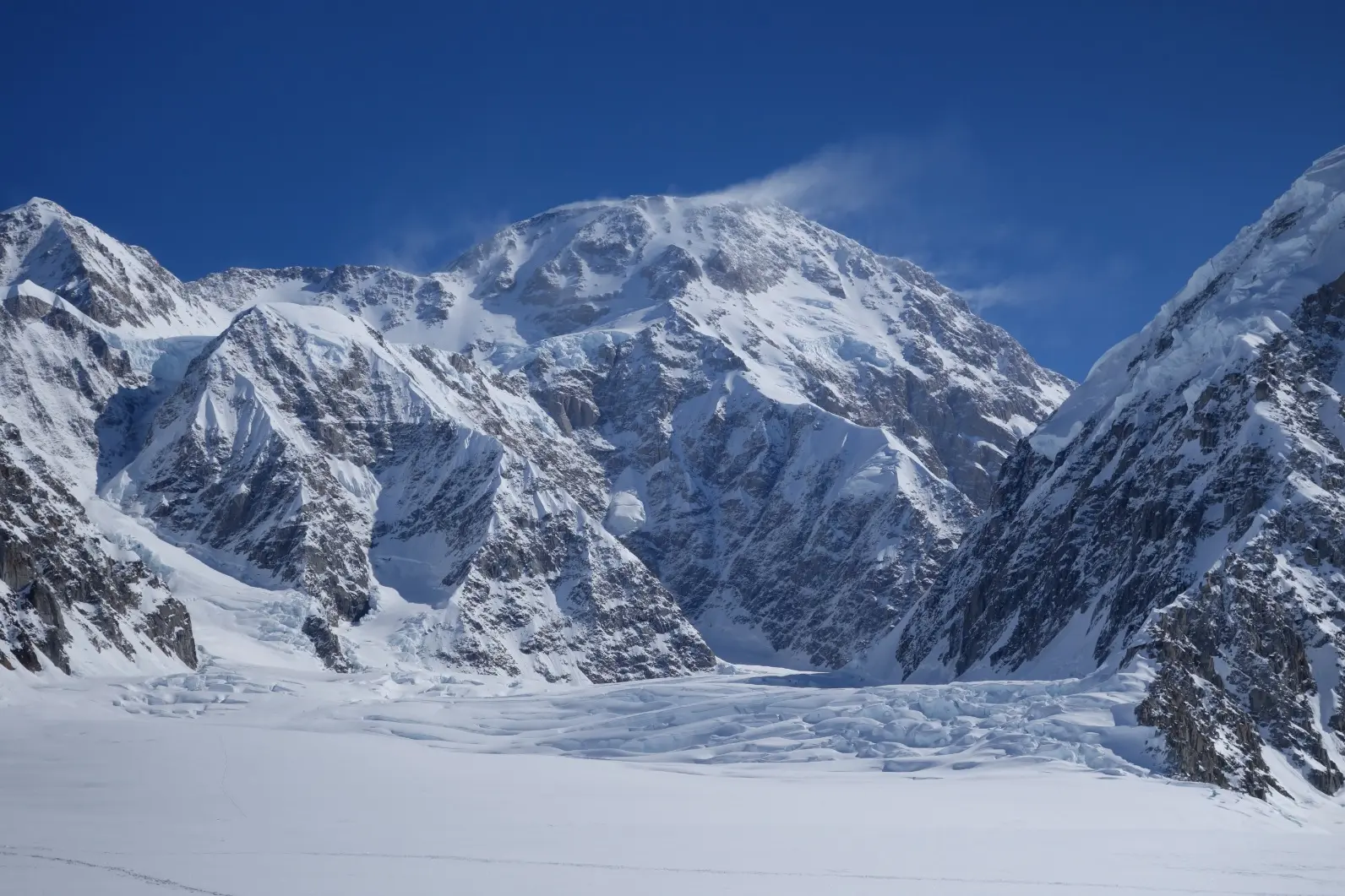 Climbers hauling sleds across the Kahiltna Glacier on Denali in Alaska during an Alpenglow Expeditions guided mountaineering expedition