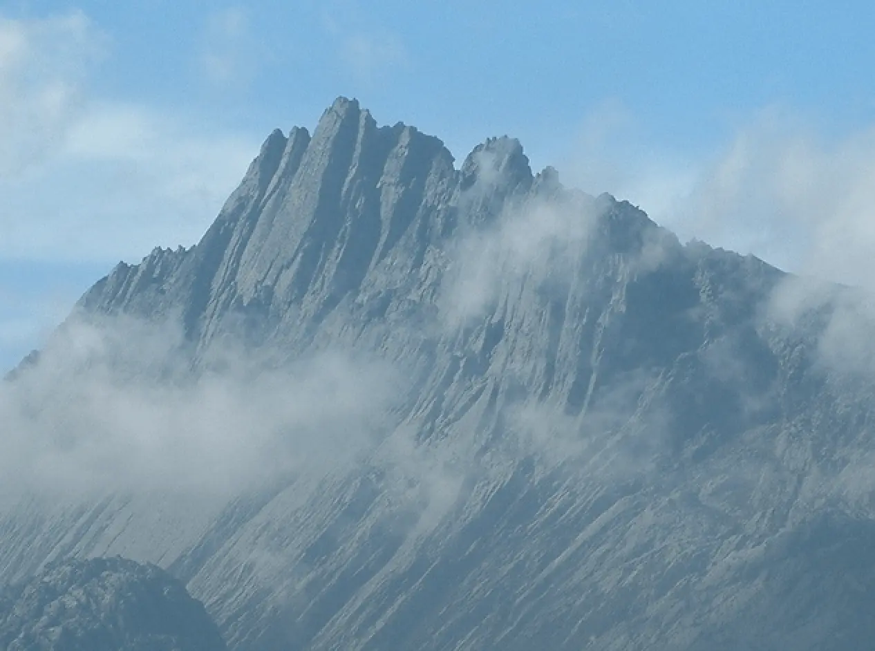 The jagged rocky summit ridge of Carstensz Pyramid in West Papua during an Alpenglow Expeditions guided Seven Summits expedition