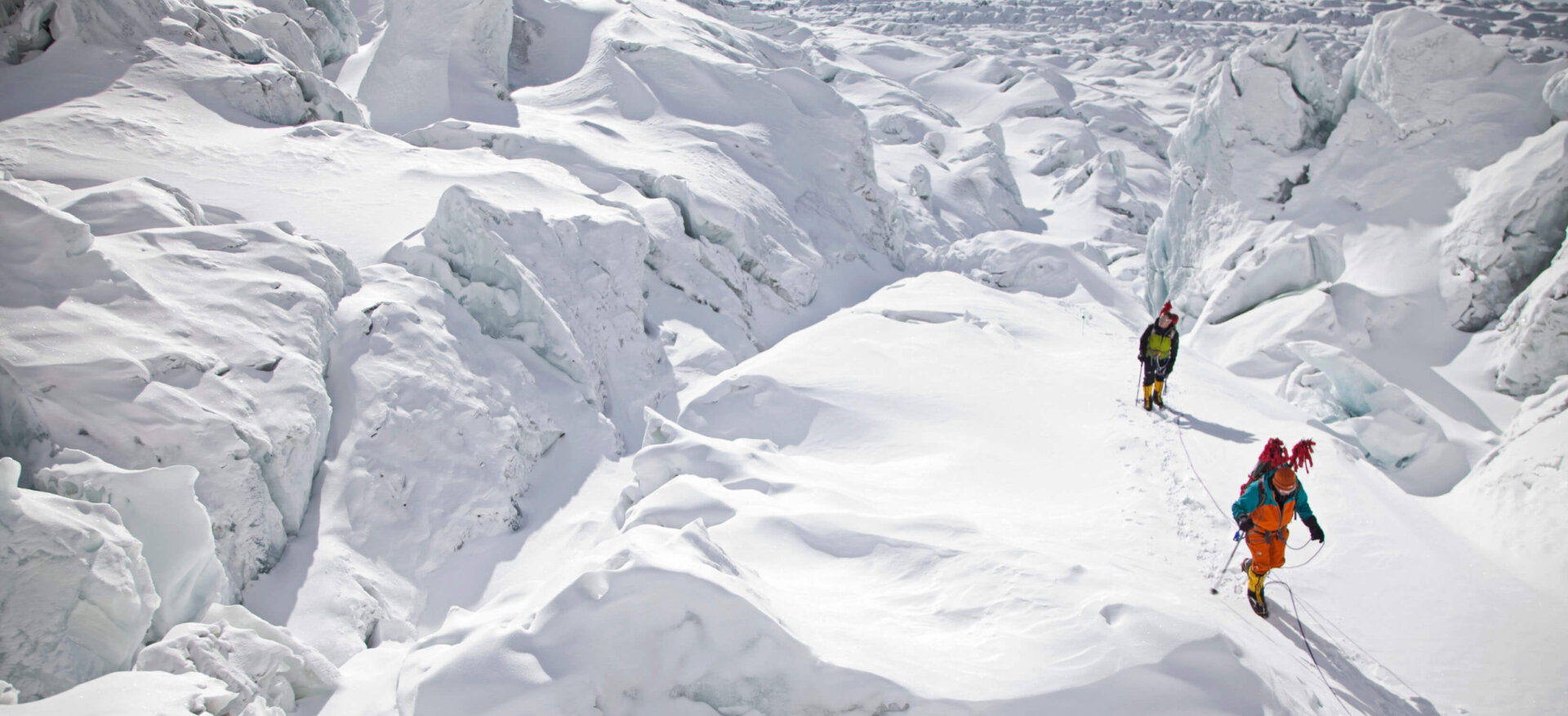 Two mountaineers navigating a glacier on a Gasherbrum II Expedition