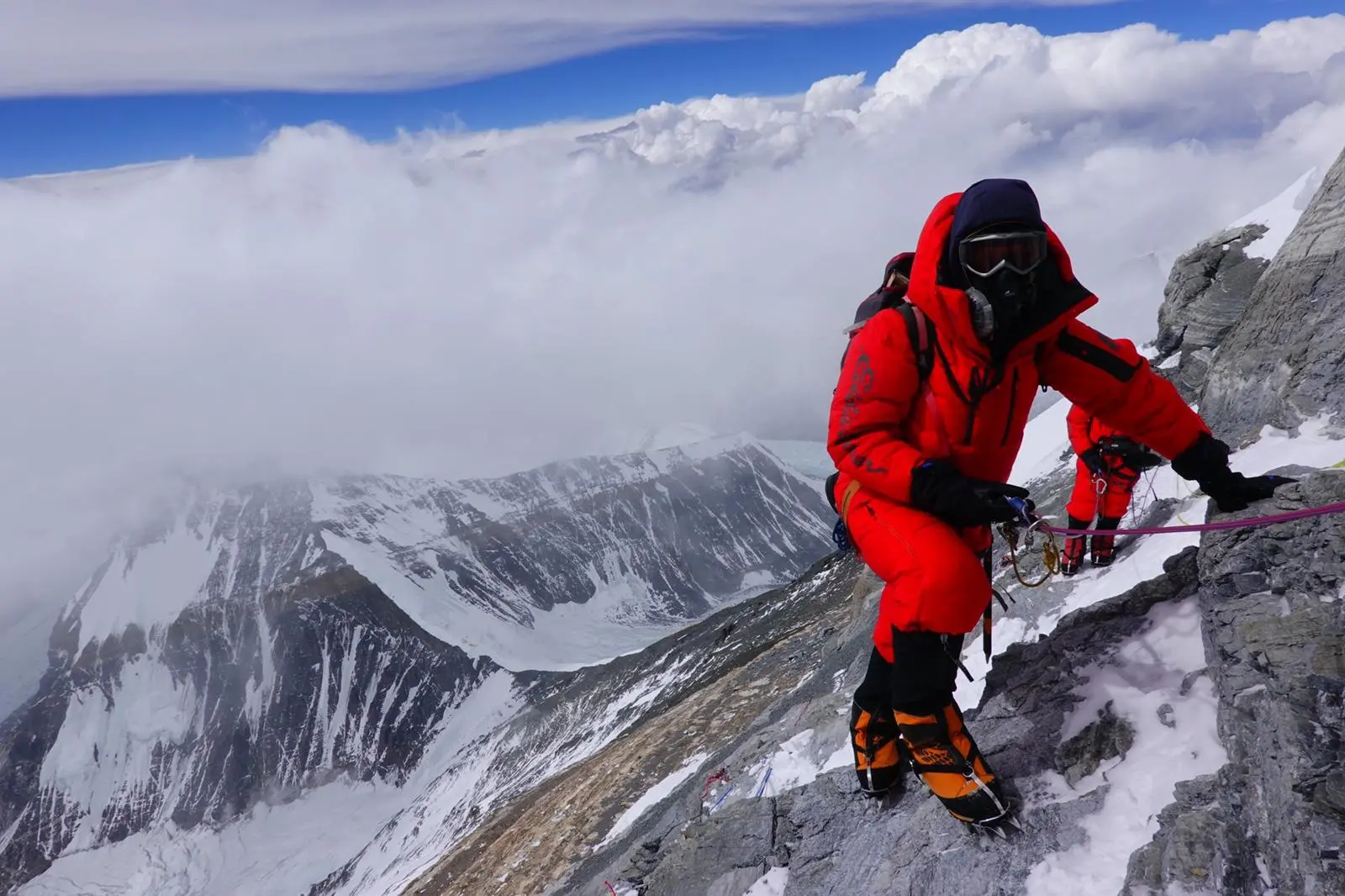 Climbers standing near the summit of Mount Everest from the North Side with Alpenglow Expeditions.