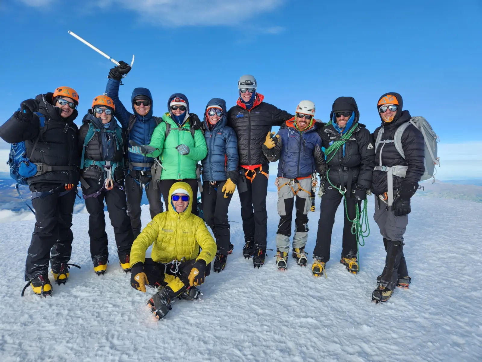 Group of students on the summit of a volcano in Ecuador during Alpenglow Expeditions' Ecuador Climbing School, intro to high-altitude mountaineering course