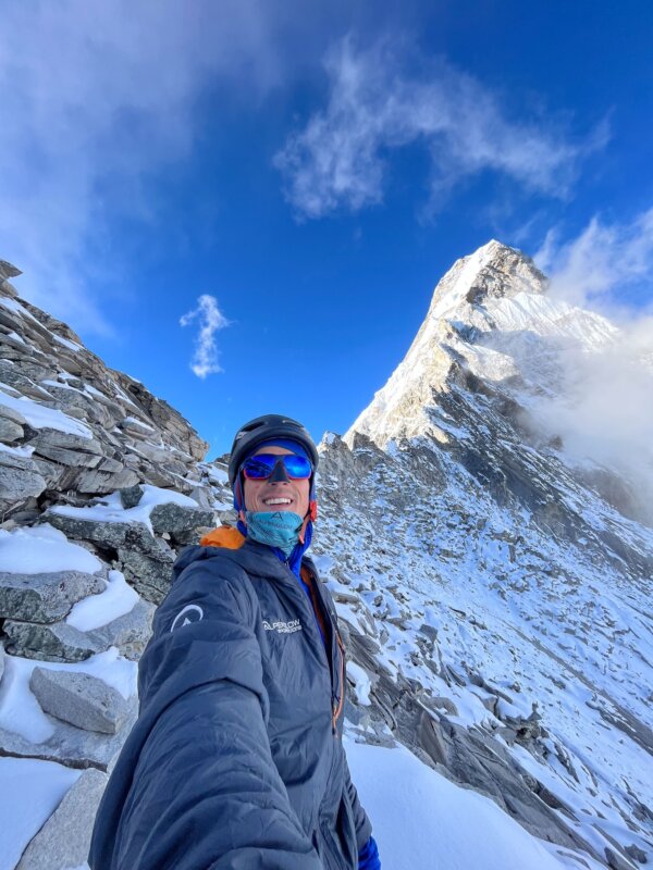 A guide takes a selfie below the summit of Ama Dablam