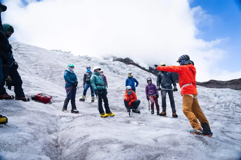 Ecuador Climbing School guide on glacial ice with clients