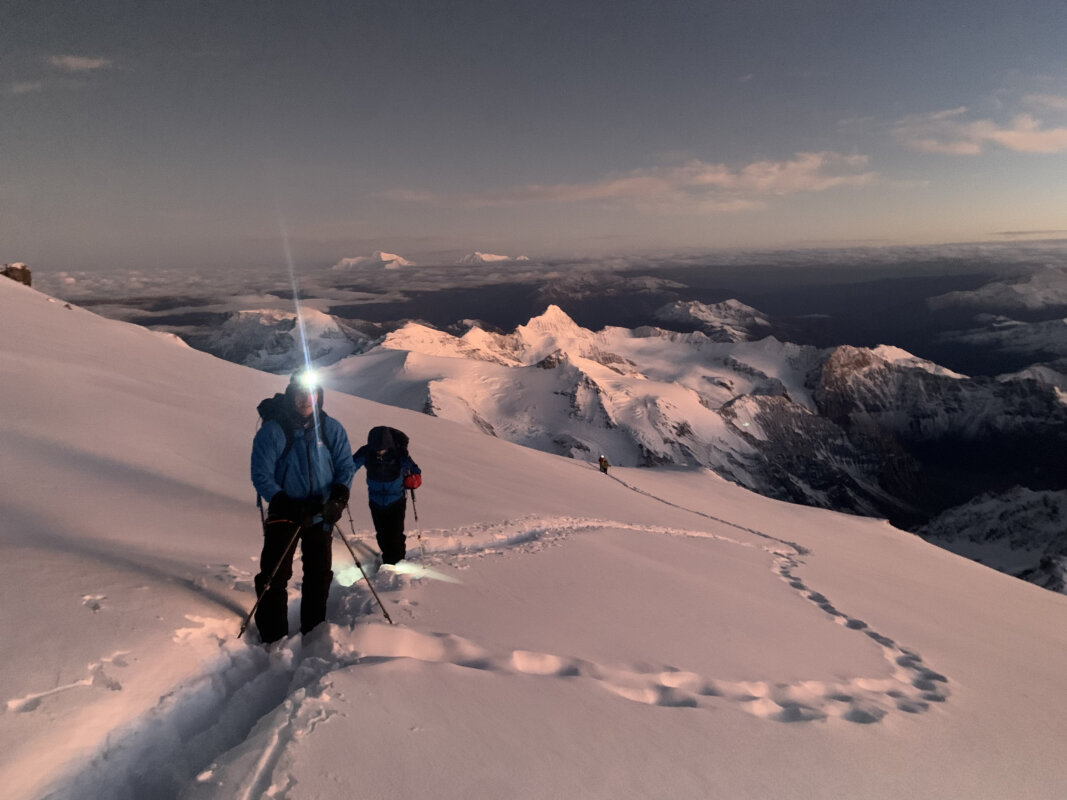 Two mountaineers climbing up Aconcagua at sunrise