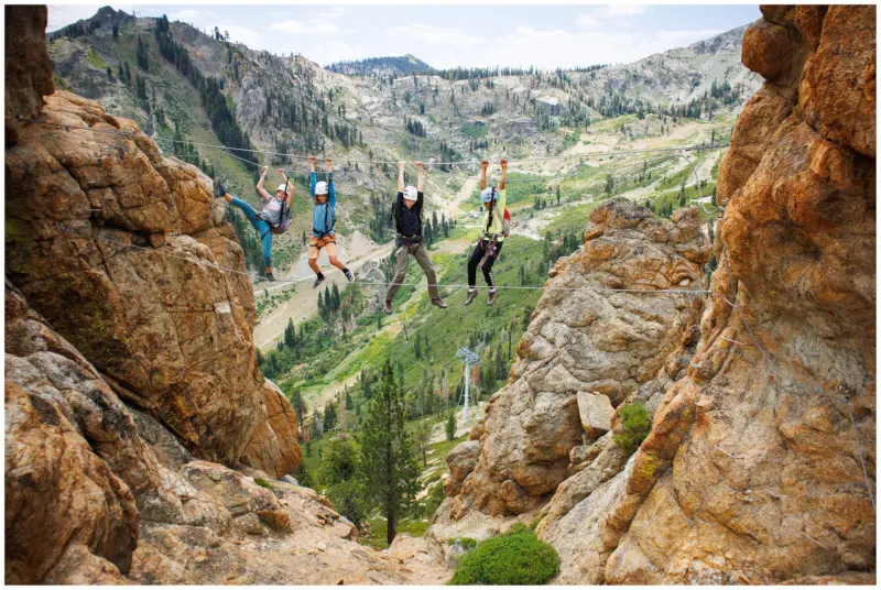A group of kids hanging on the Tahoe Via Ferrata during a Kids Rock Climbing Camp in Lake Tahoe.