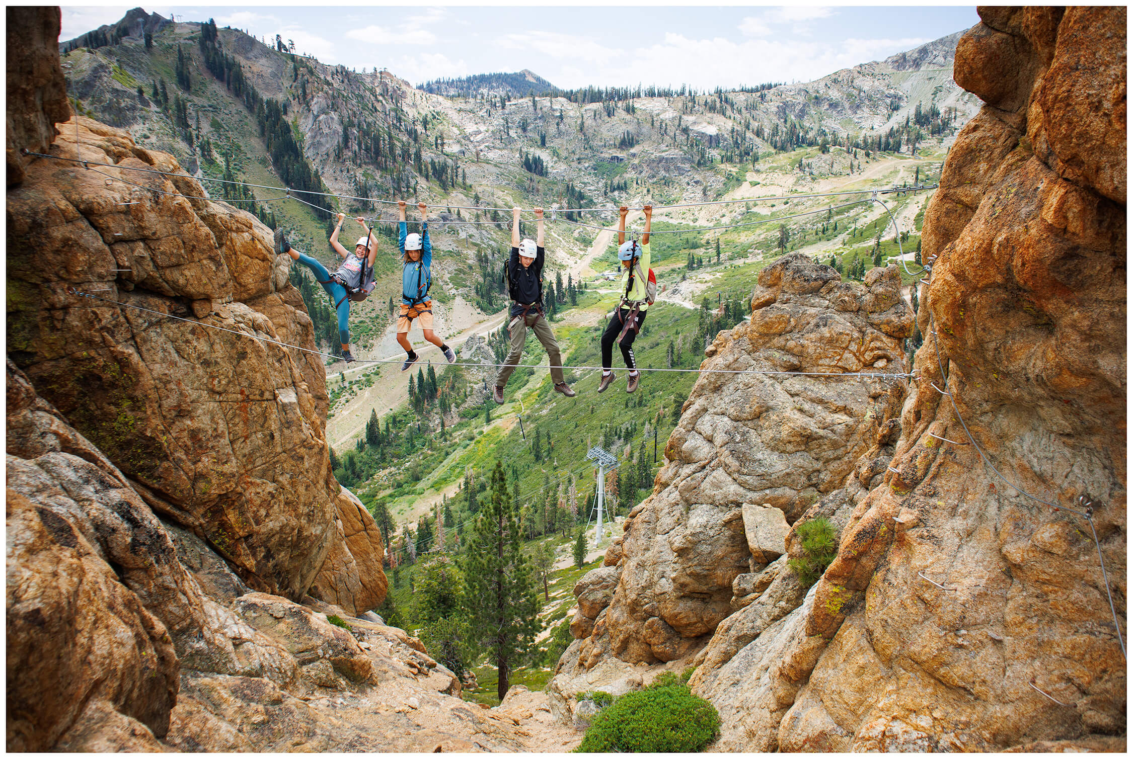A group of kids hanging on the Tahoe Via Ferrata during a Kids Rock Climbing Camp in Lake Tahoe.