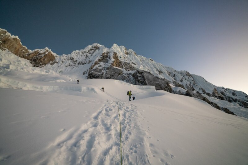 Climbers alpine climbing up a glaciated slope on an Alpamayo Expedition
