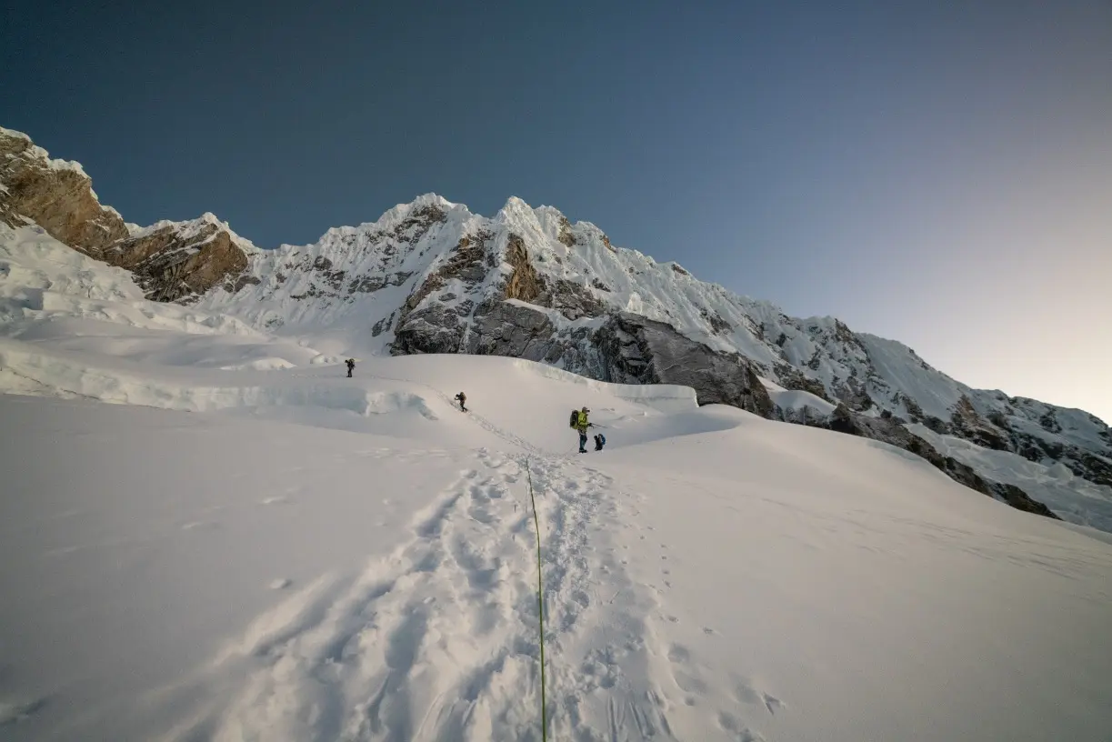 Climbers alpine climbing up a glaciated slope on an Alpamayo Expedition