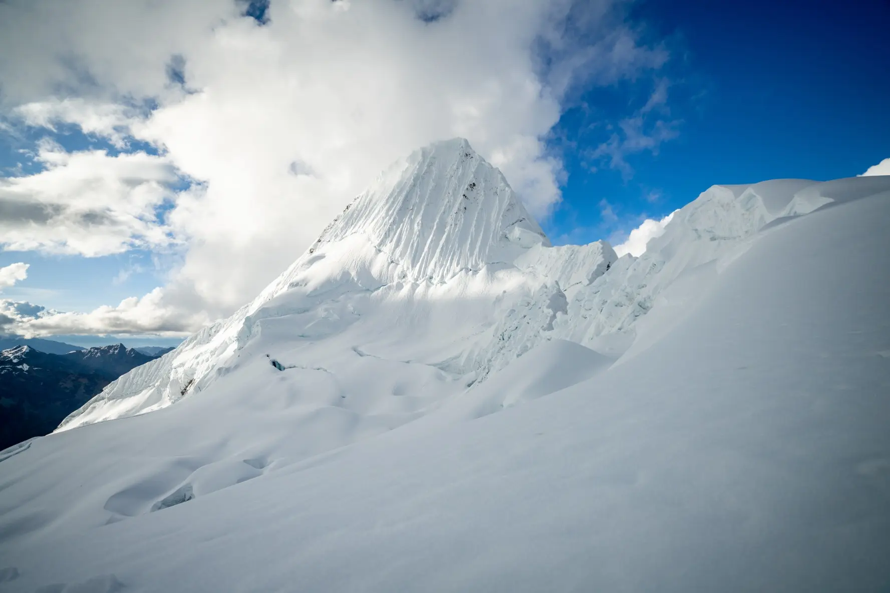 Mountaineers ascending the steep ice face of Alpamayo in Peru's Cordillera Blanca during an Alpenglow Expeditions guided expedition