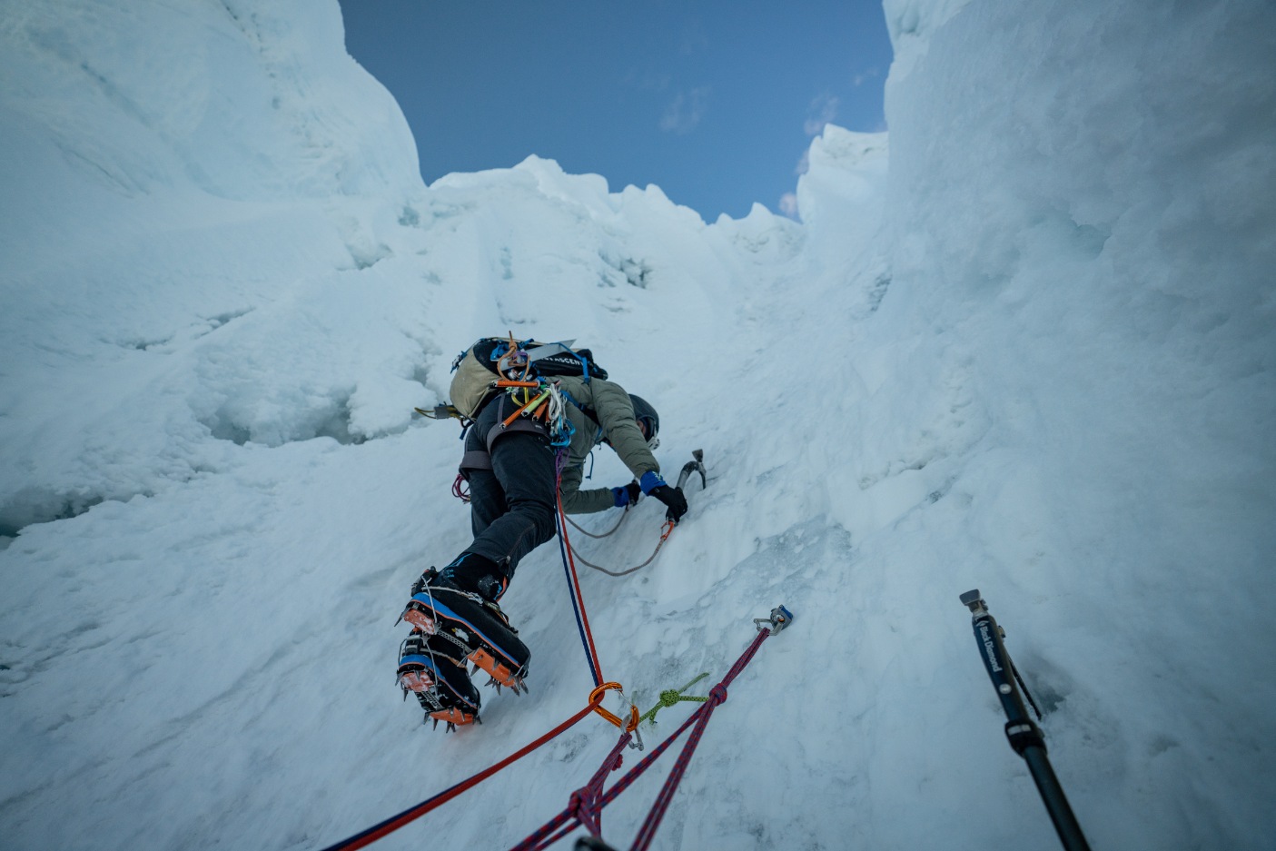 A climber alpine climbing up an Alpamayo fluted spine before the summit