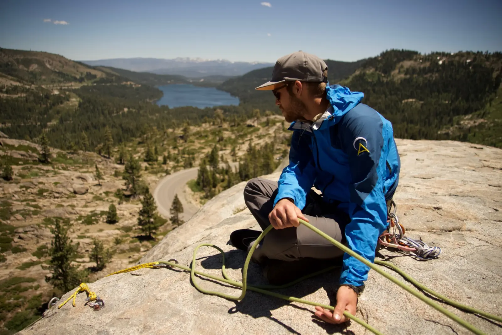 Mountain guide belays from ledge during a Private Half Day of Rock Climbing with Alpenglow Expeditions