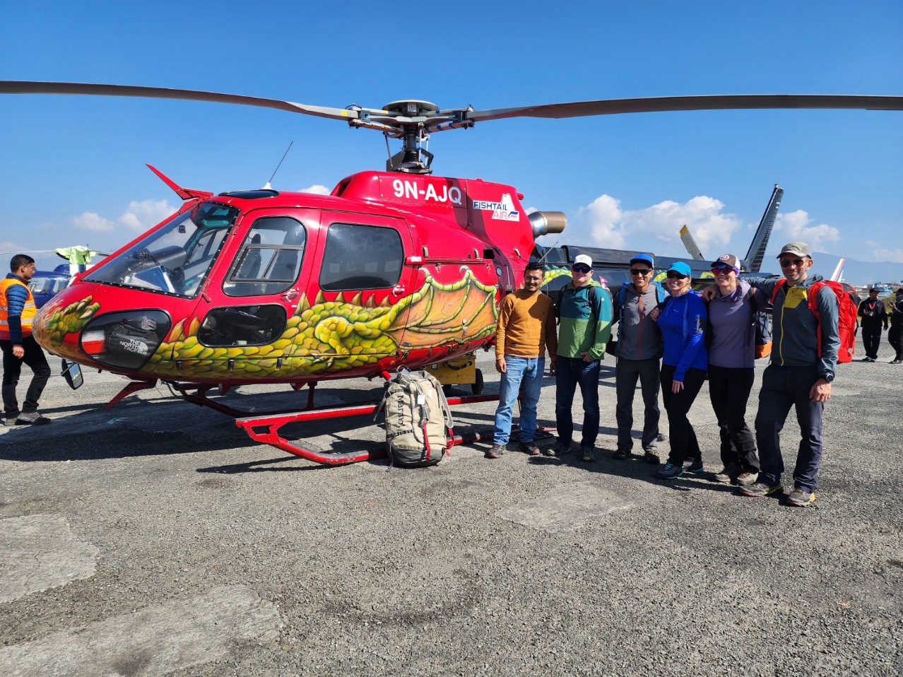 Ama Dablam Expedition clients standing in front of a helicopter