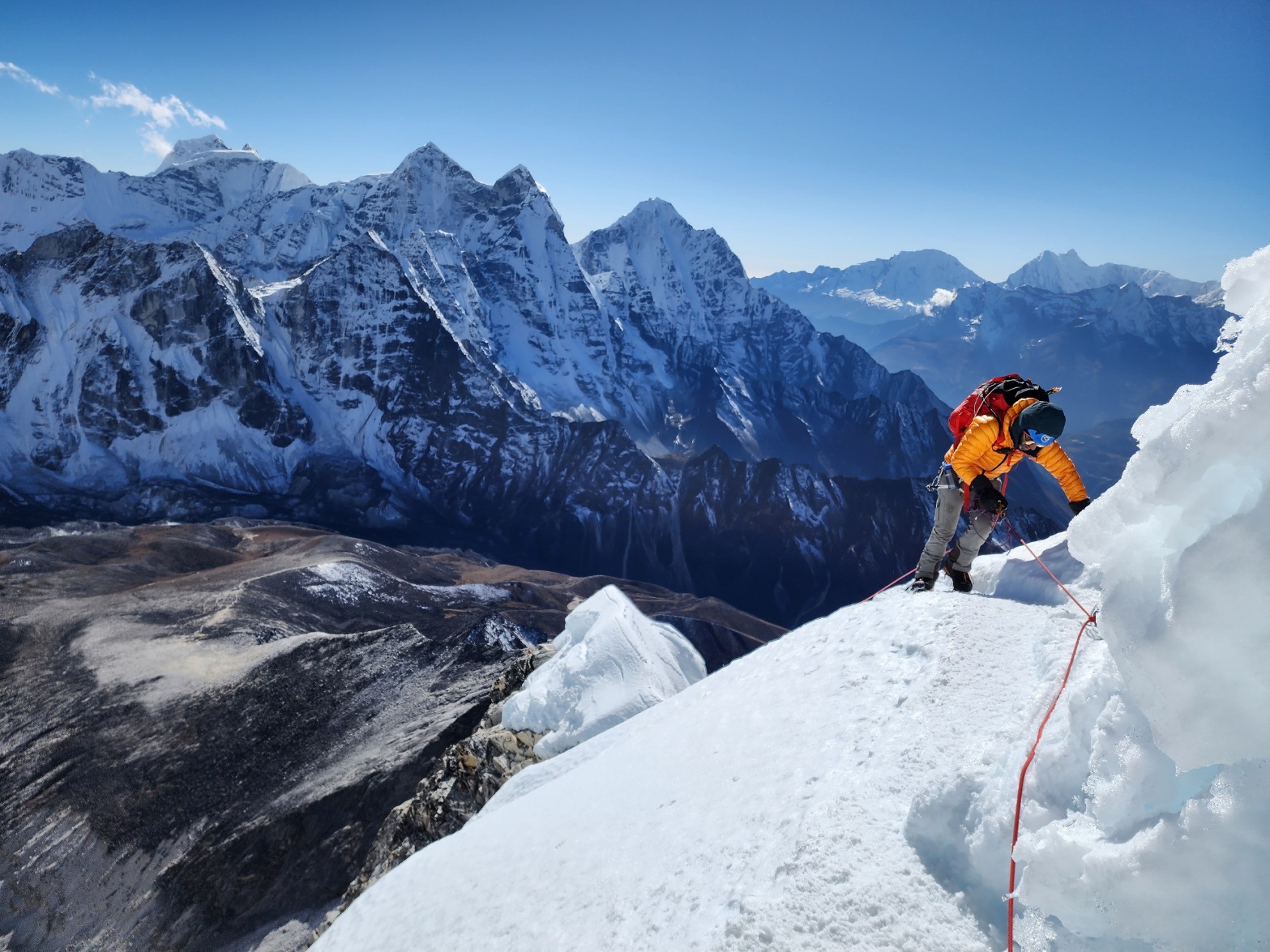A mountaineer climbing up a ridge on a guided Ama Dablam Expedition