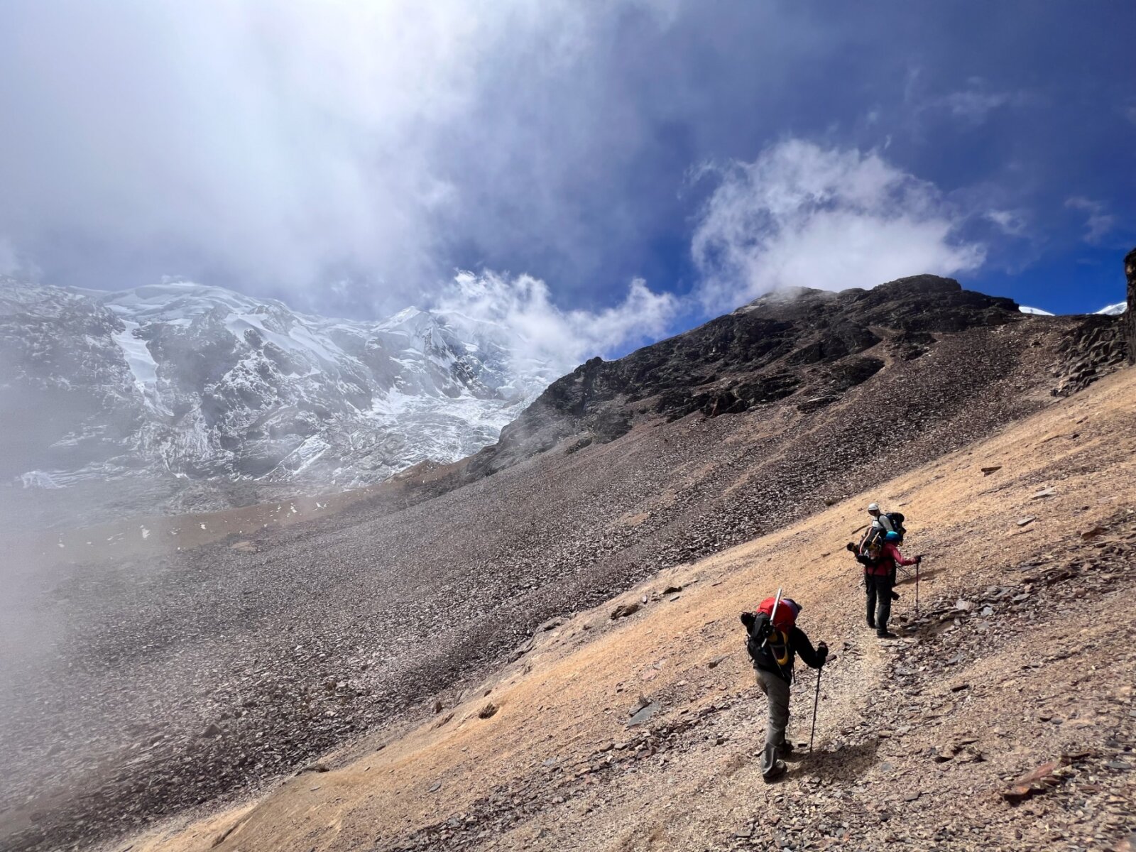 Two climbers hiking up a mountain in Bolivia during a guided expedition