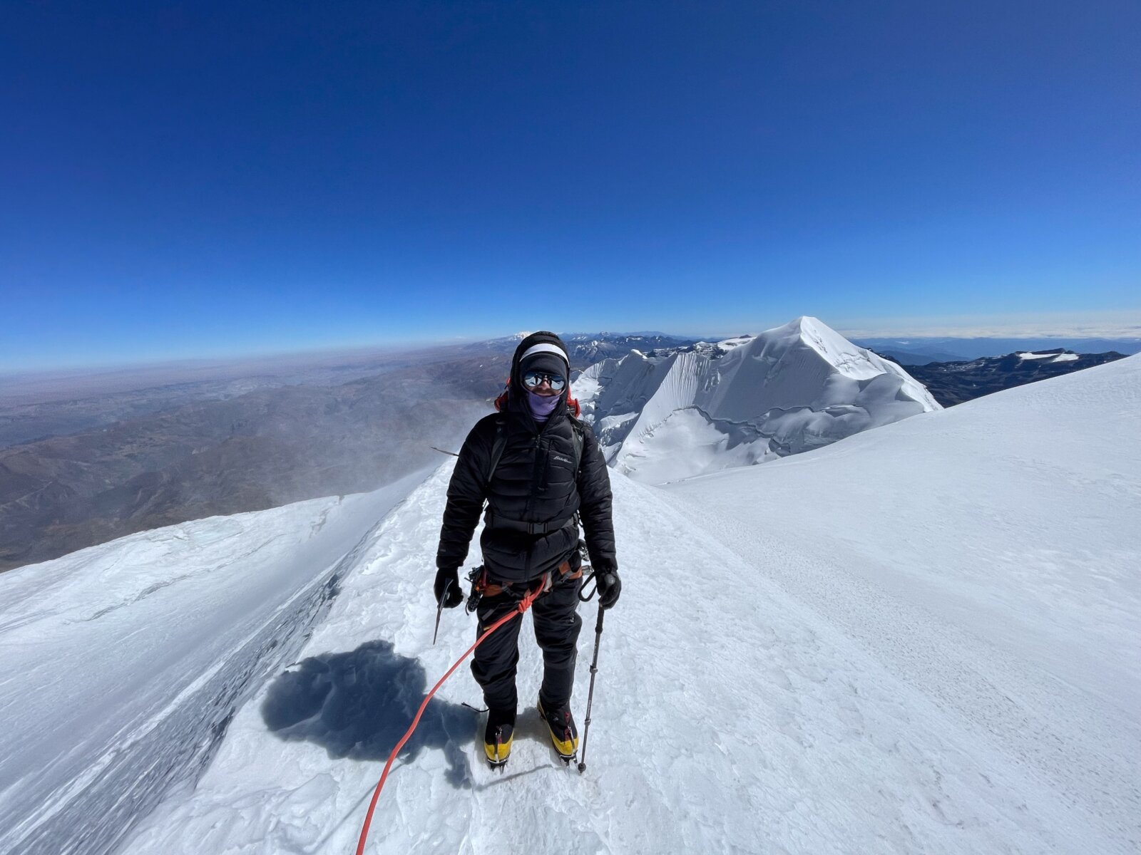 Mountaineer climbing up the ridge to the summit during a Bolivia Expedition