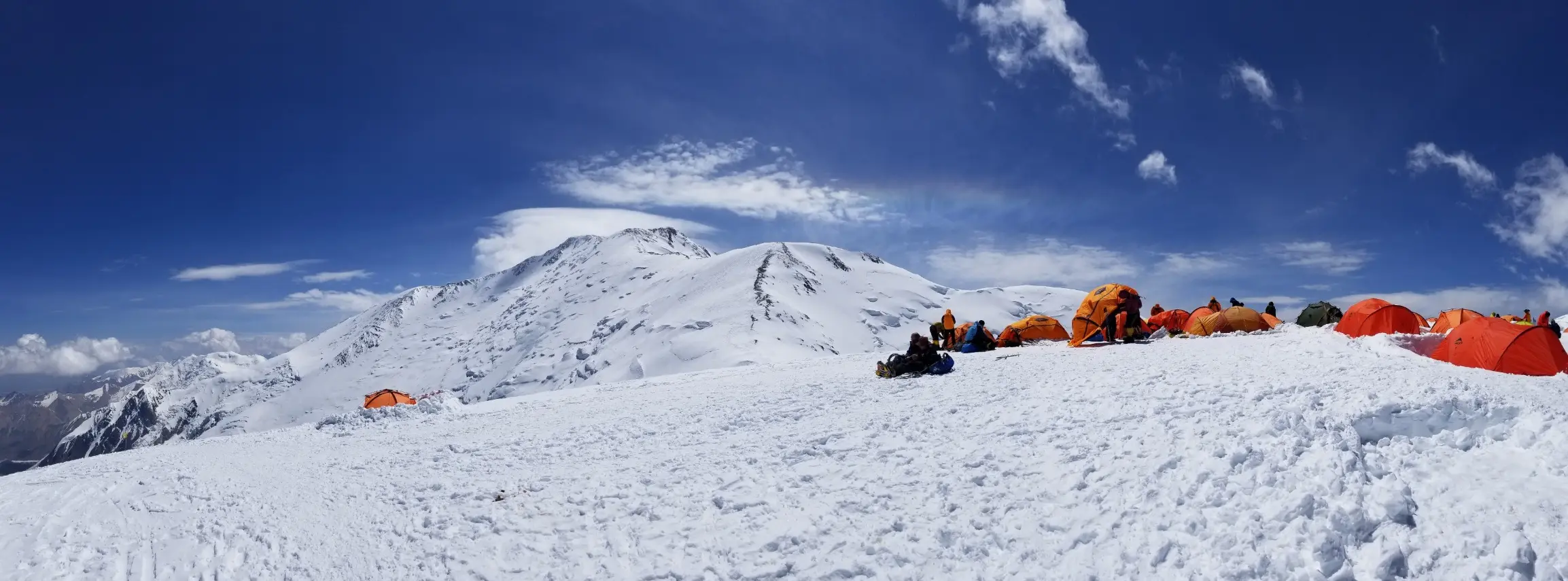 Tents on a ridge at a high camp on Peak Lenin during an expedition with Alpenglow Expeditions.