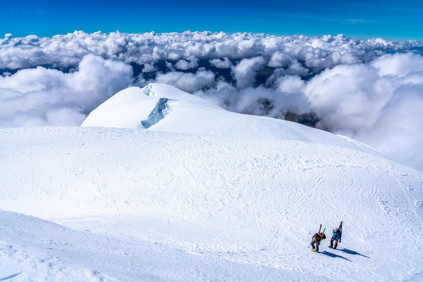 Two ski mountaineers on a snowy slope of a volcano in Ecuador with Alpenglow Expeditions' professionally guided ski mountaineering trip to Ecuador's Ring Of Fire.