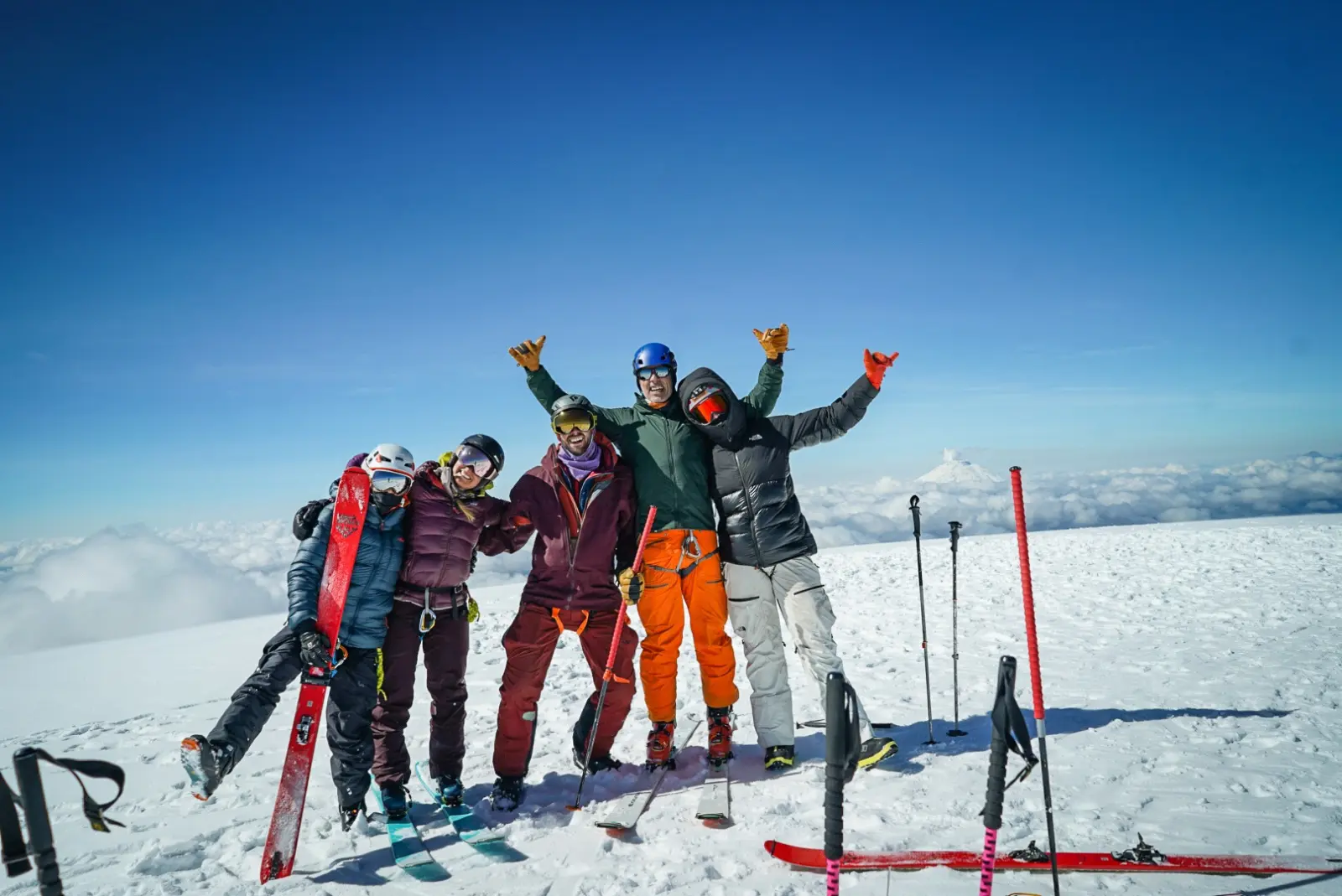 Ski mountaineers on the summit of a volcano in Ecuador during an Alpenglow Expeditions guided Ring of Fire backcountry ski expedition
