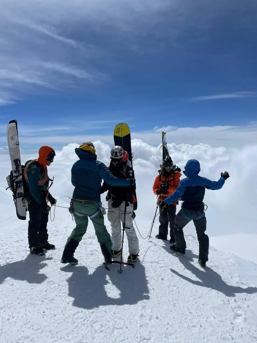 A group of ski mountaineers on the summit of a volcano in Ecuador with Alpenglow Expeditions' professionally guided ski mountaineering trip to Ecuador's Ring Of Fire.