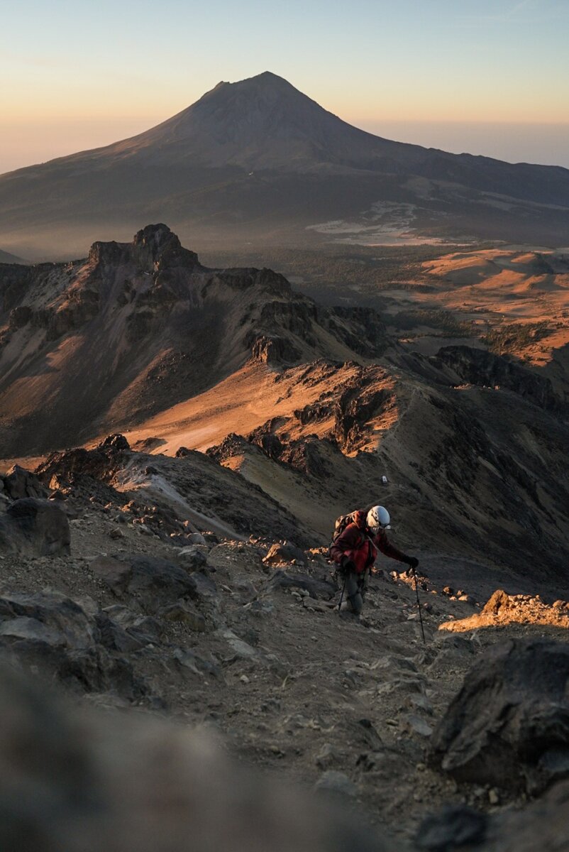 Climber hiking up a rocky slope on a guided Volcanoes of Mexico Expedition