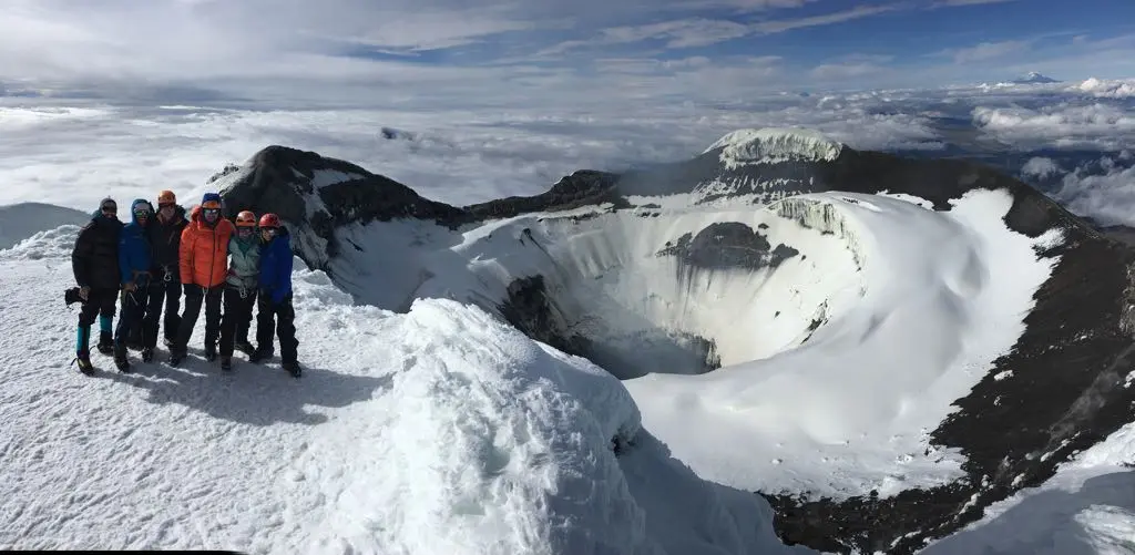 Climbers near the summit crater of Cotopaxi volcano in Ecuador at dawn during an Alpenglow Expeditions Rapid Ascent™ guided expedition