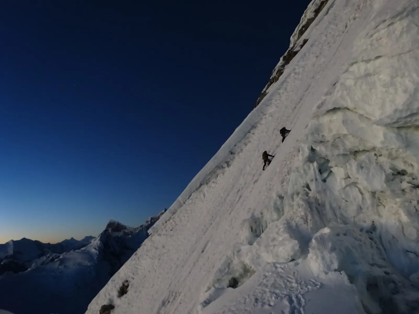 Mountaineers alpine climbing up a glaciated slope on a guided Artesonraju Expedition