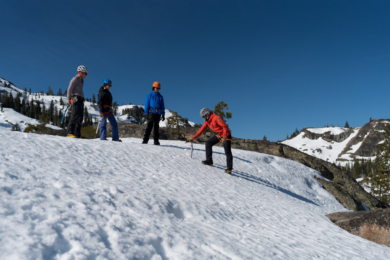 Guide teaches a group of students Mountaineering skills, like glacier travel and crevasse rescue, near Lake Tahoe in the Sierra Nevada mountains with Alpenglow Expeditions' professional mountain guides.