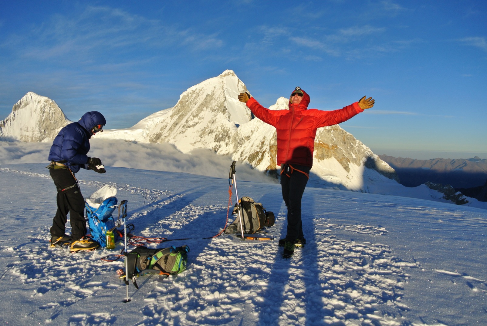 Clients raising their arms in triumph while climbing Pisco and Chopicalqui