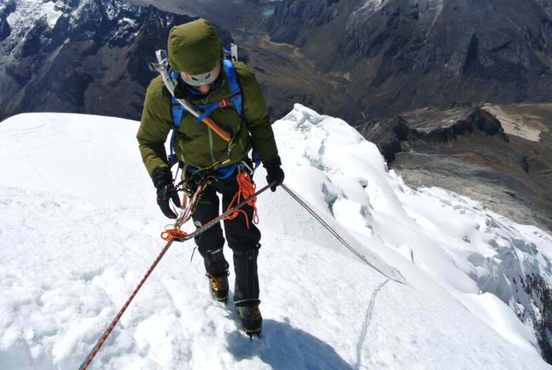 A climber roped in, climbing up Artesonraju on a guided expedition