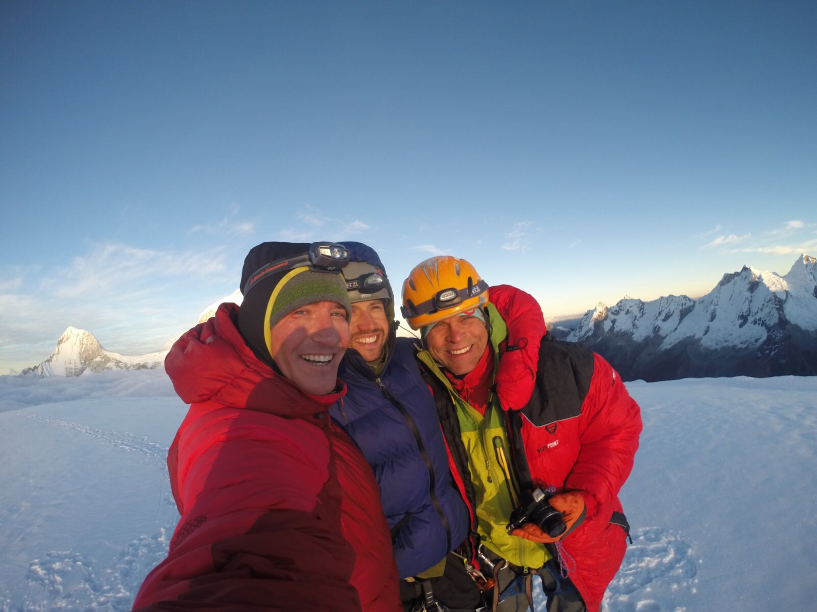 Three climbers taking a selfie on the summit of Pisco and Chopicalqui