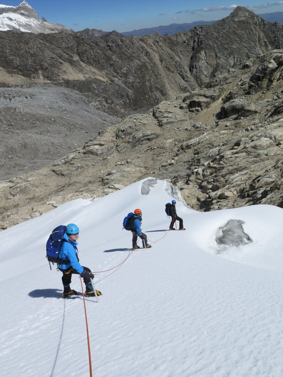 Mountaineers descending a fixed rope on a glacier in Peru.