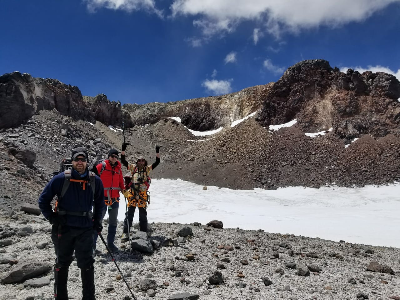 A group of clients hiking during an acclimatization hike on a guided Ojos Del Salados Expedition