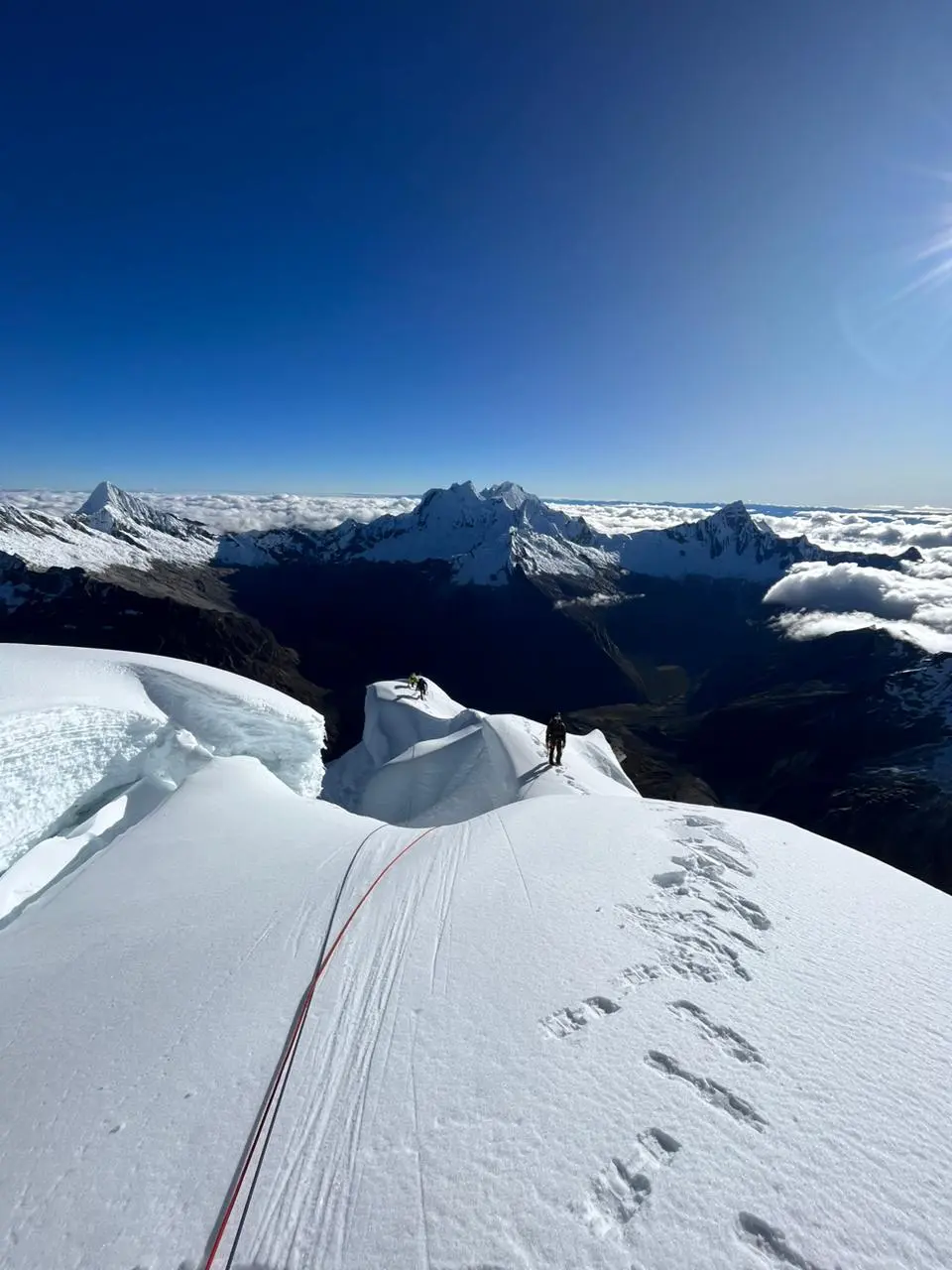 A mountaineer climbing up a snowy ridge during an Artesonraju Expedition