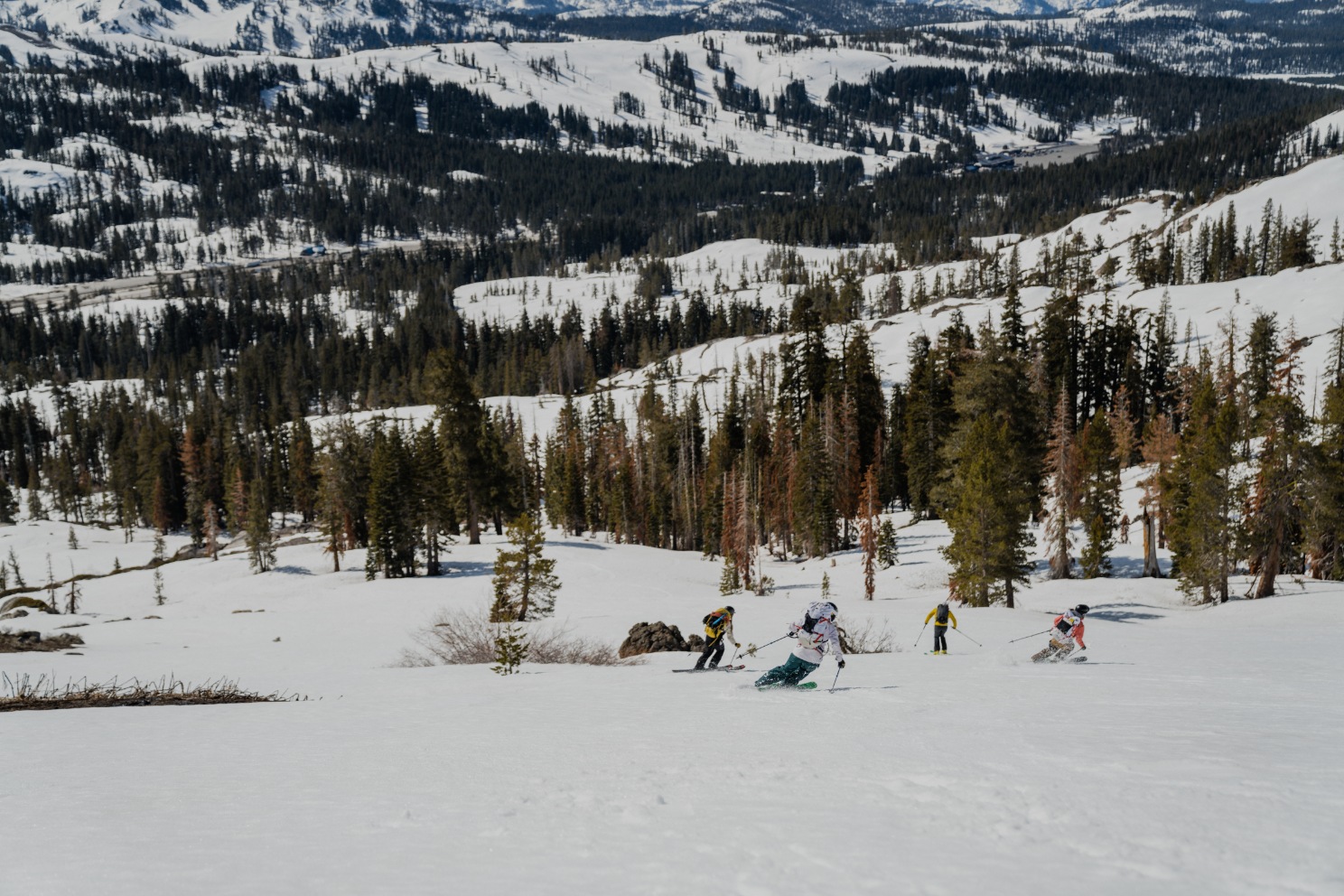 Clients skiing down a slope during a private backcountry ski guiding in lake tahoe with professional mountain guides
