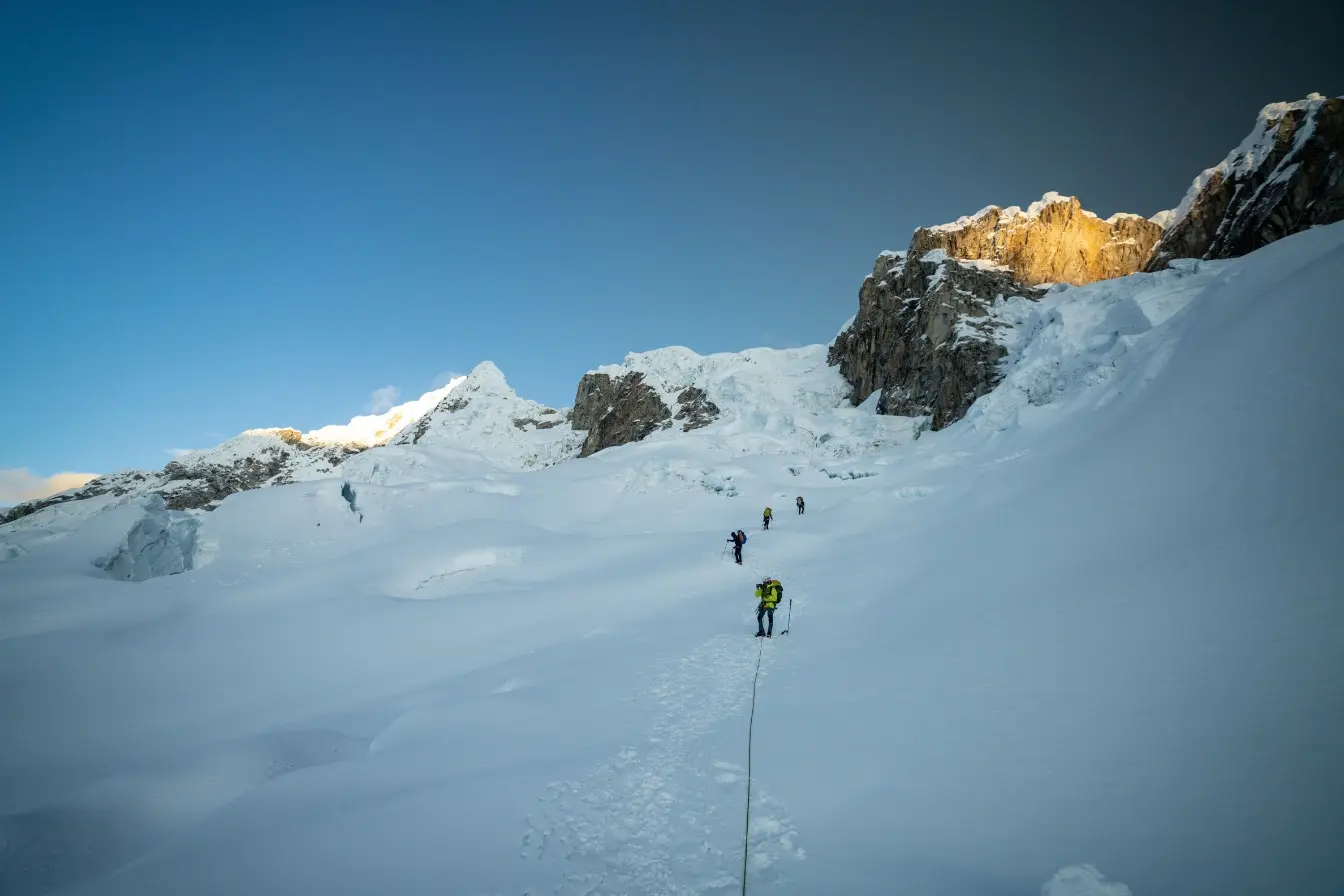 Climbers alpine climbing up a glaciated slope on an Alpamayo Expedition