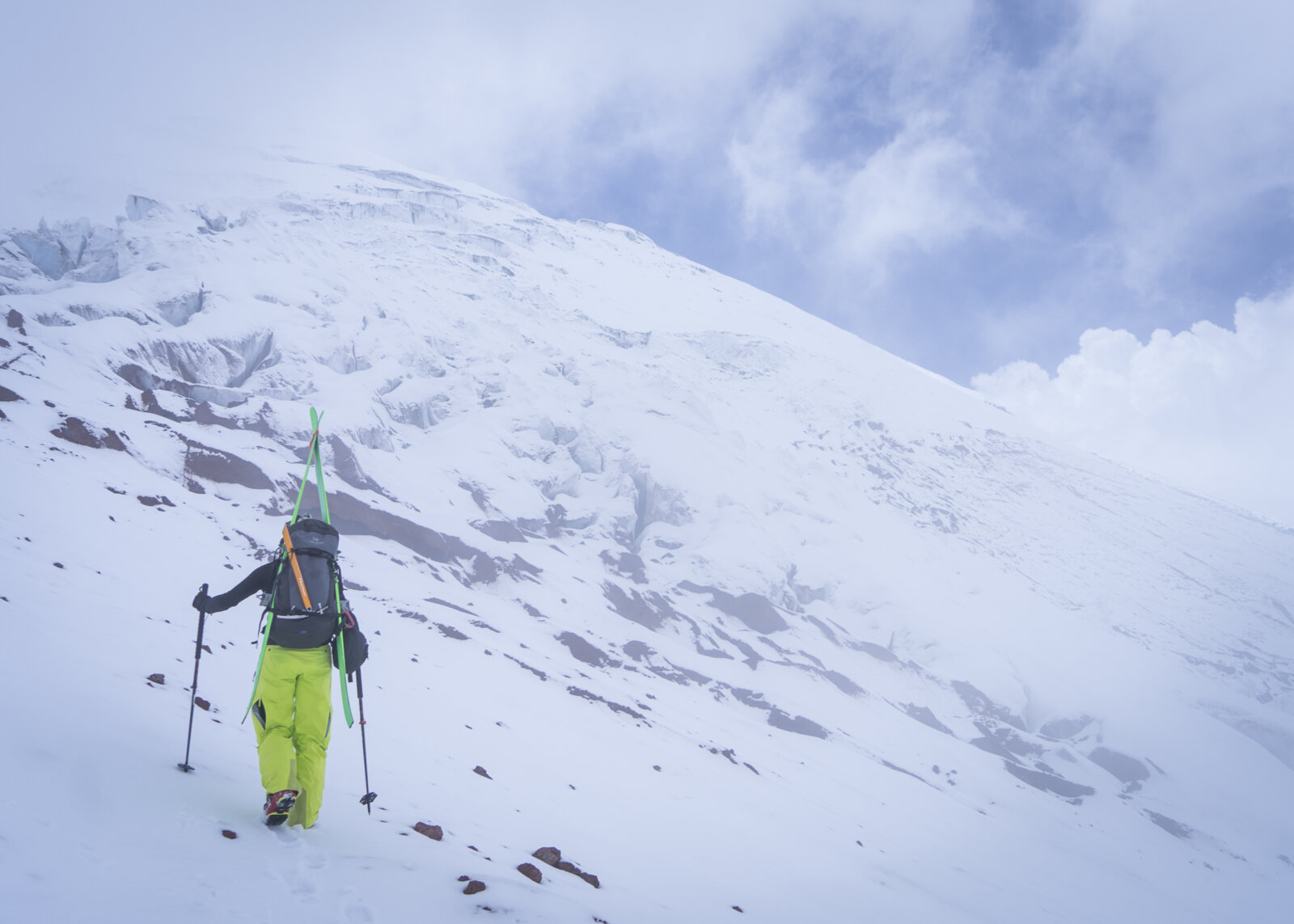 A climber heading up the route with skis to climb and ski Cotopaxi.