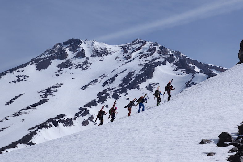 A group of six skiers climb up the snowy slopes of Mt. Shasta.