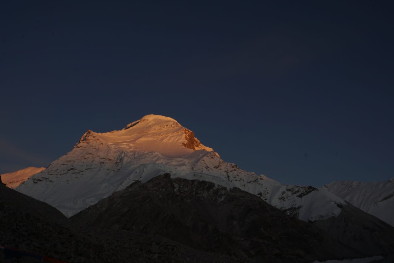 the sun sets on the summit of Cho Oyu