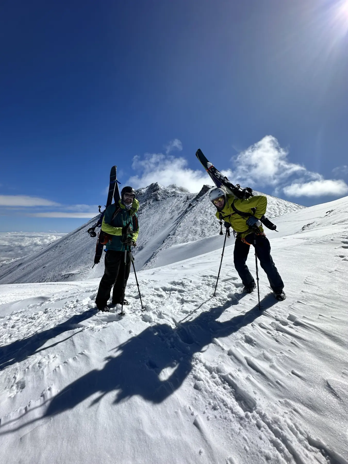 Two ski mountaineers hiking up to ski Mount Shasta with Alpenglow Expeditions