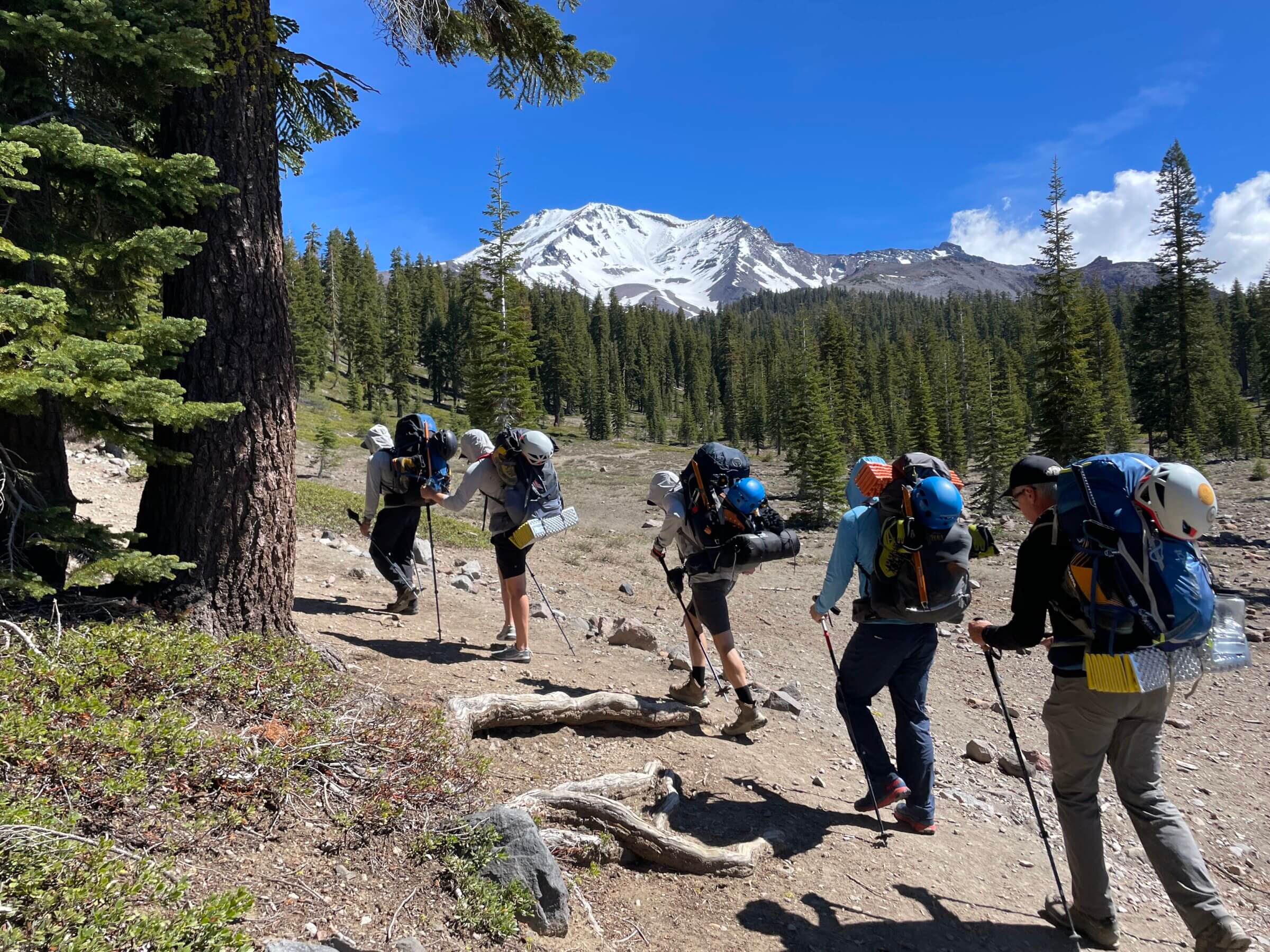A group of backpackers heading to climb Mount Shasta with Alpenglow Expeditions