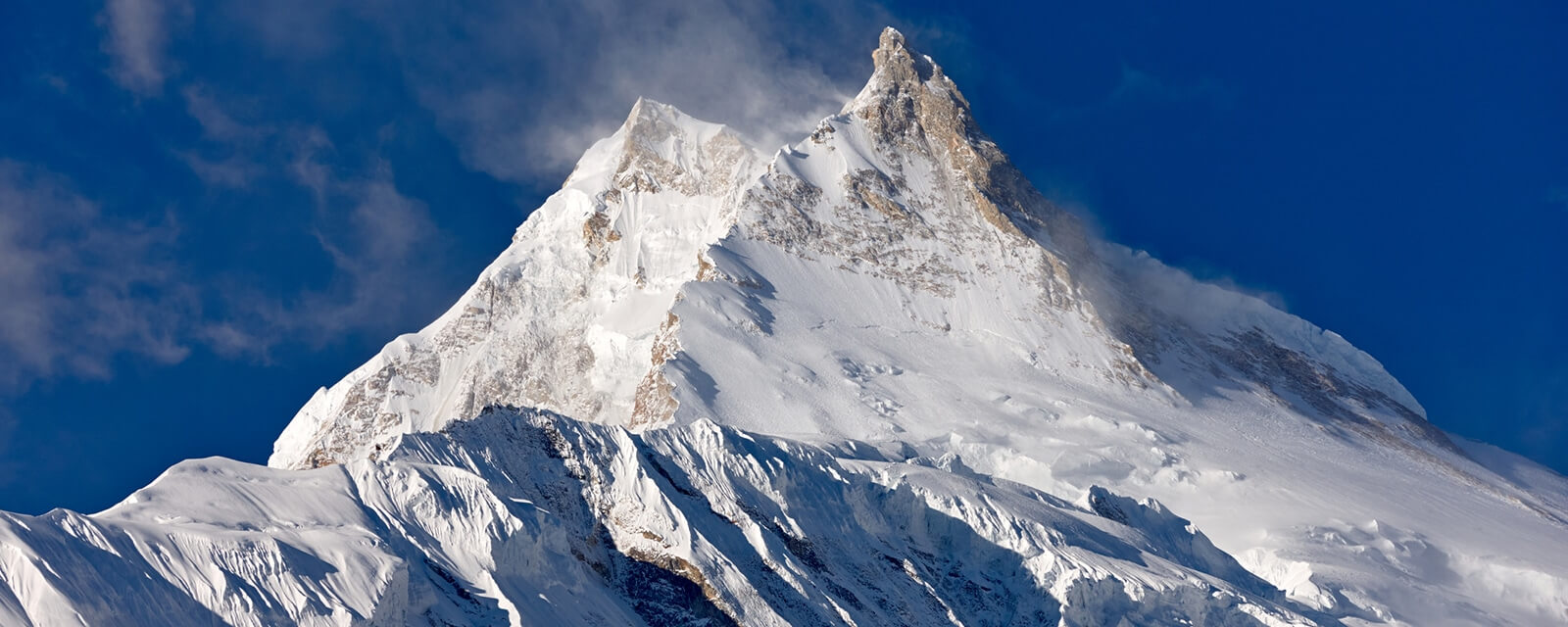 Manaslu is a large, snow covered peak in the Himalaya. It is the eight tallest mountain in the world. 