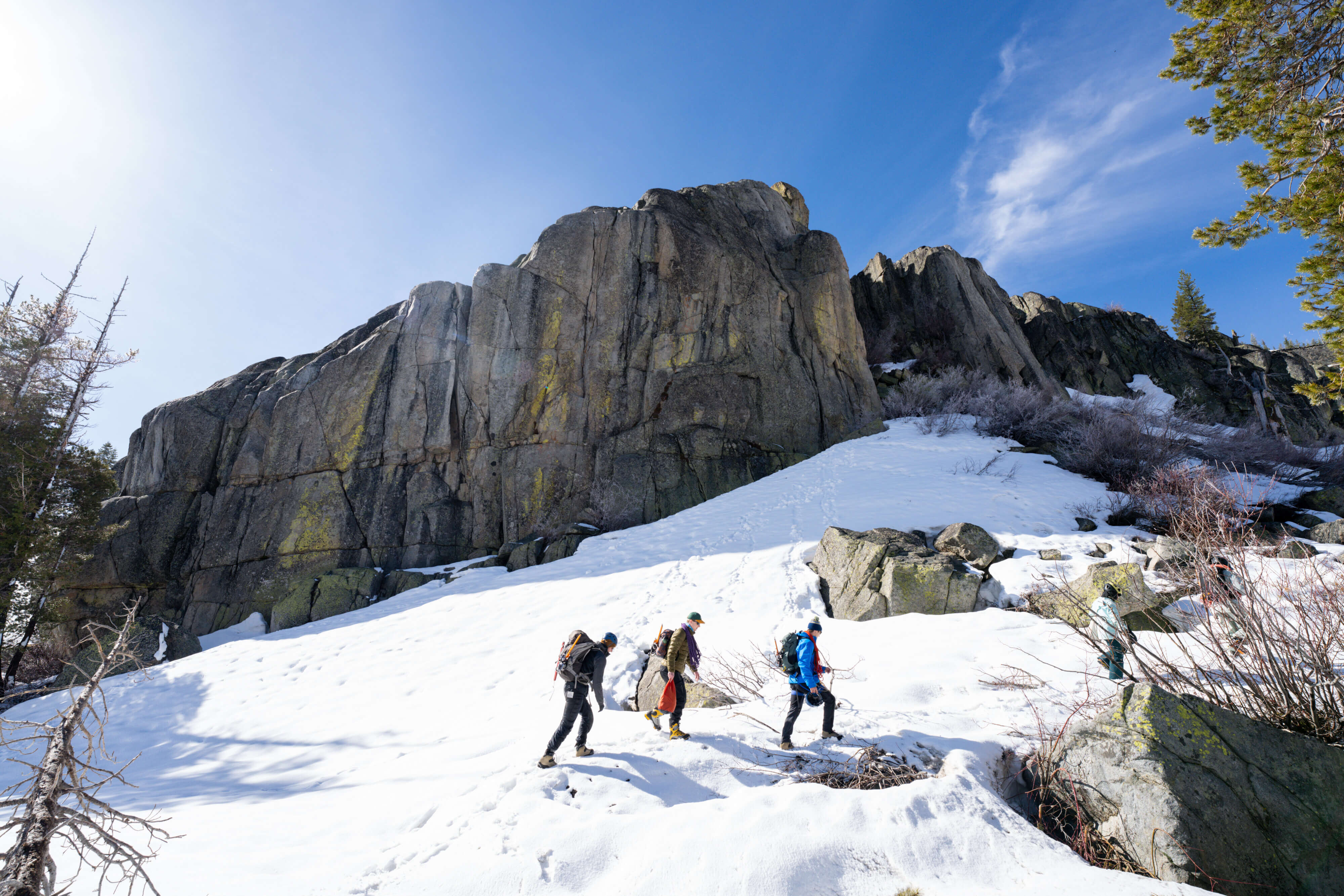 Climbers walk on snow in front of Snowshed on Donner Summit during an intro to mountaineering course in Tahoe