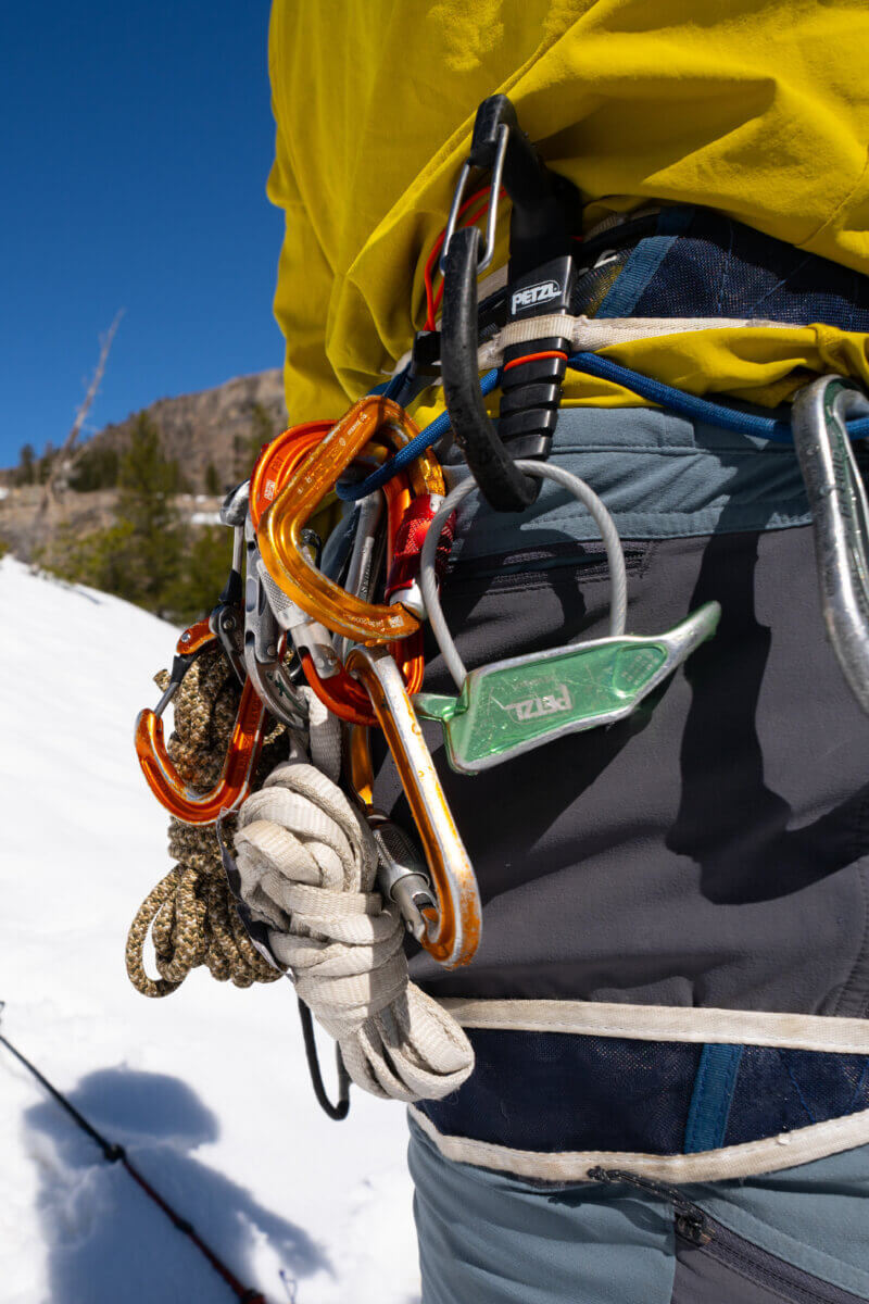 A guide's harness loaded with gear for an intro to mountaineering course in Tahoe.