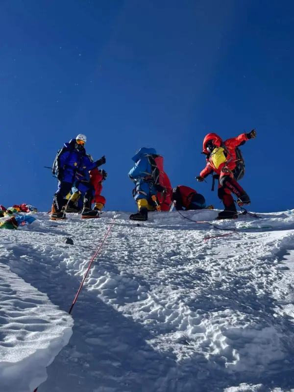 Alpenglow Expeditions 2024 Everest team standing on the summit.