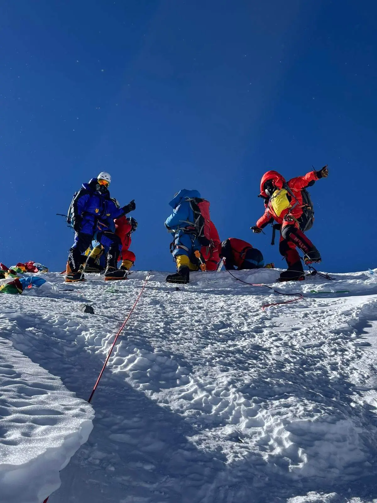 Alpenglow Expeditions 2024 Everest team standing on the summit.
