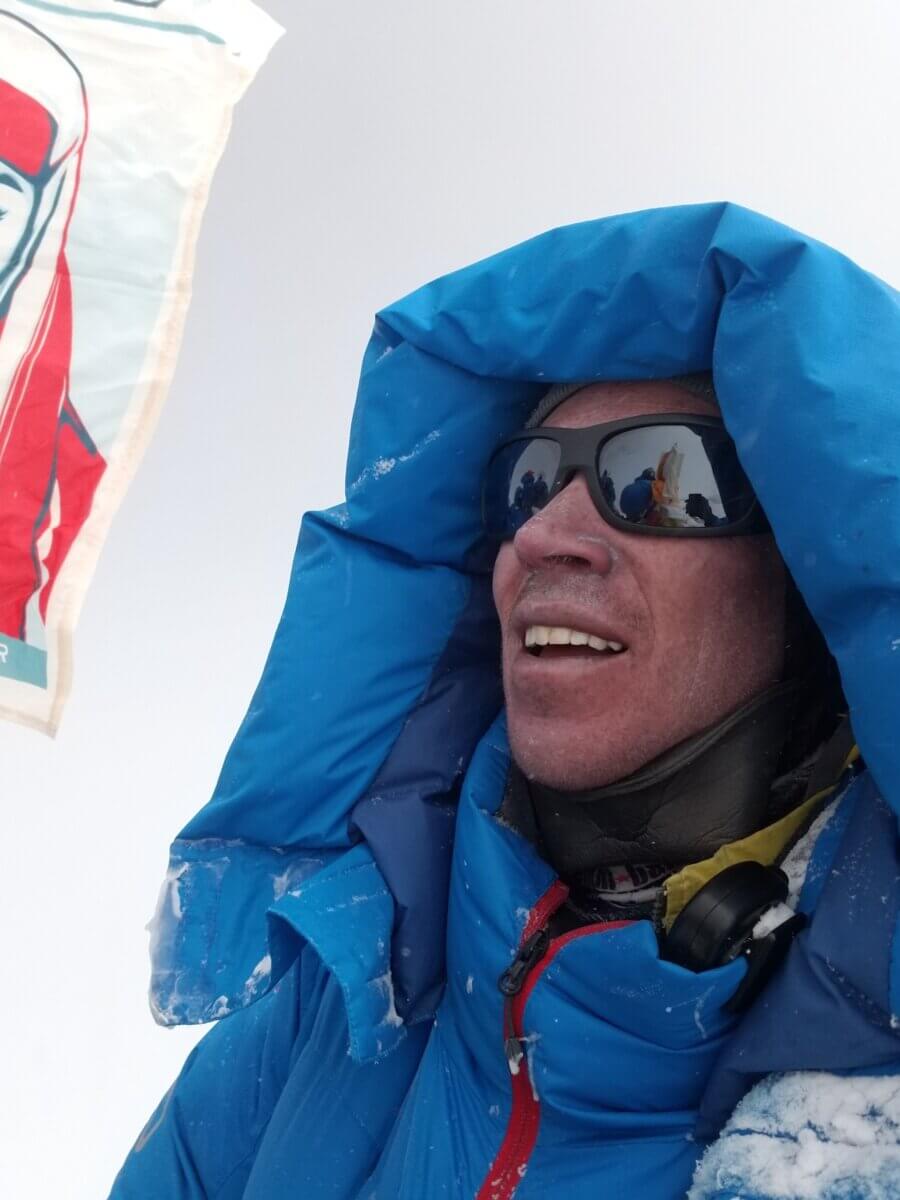 Adrian Ballinger, owner of Alpenglow Expeditions, stands on the summit of Everest after climbing without supplemental oxygen.