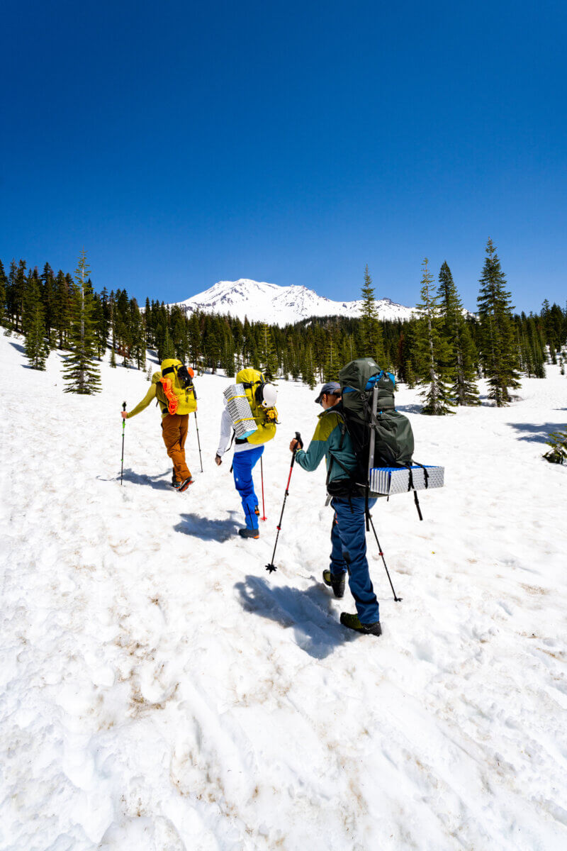 Two clients follow Alpenglow Expeditions guide as they start their West Face climb of Mount Shasta