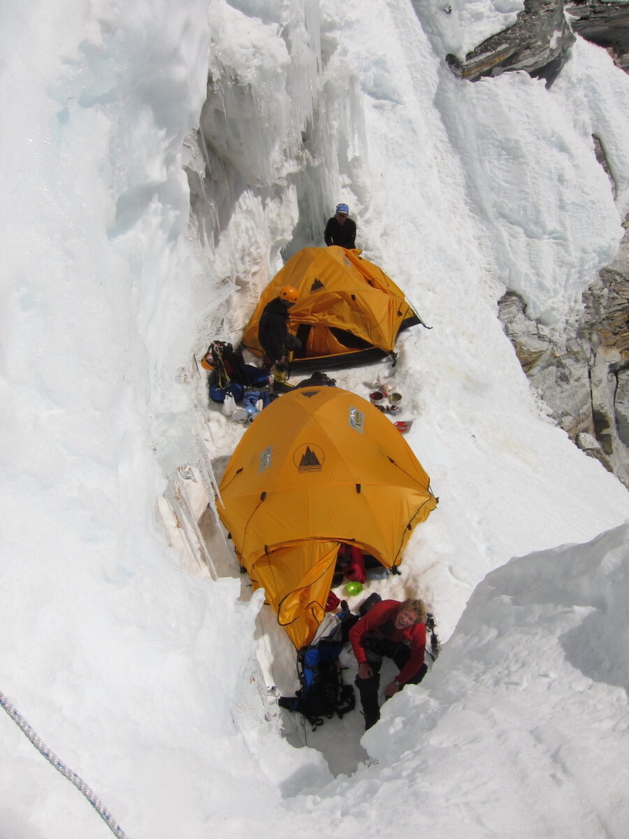 Tents sitting on a snowy slope during an expedition with Alpenglow Expeditions.